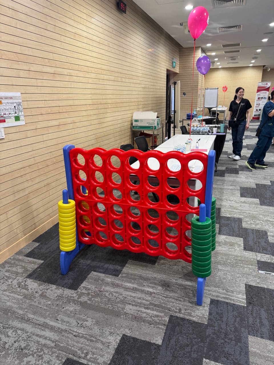 Close-up of a Giant Connect 4 game board with colorful discs stacked in play at Tan Tock Seng, Singapore