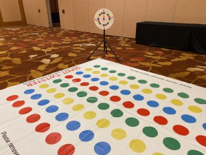 A close-up view of the red, blue, yellow, and green circles on the Giant Twister mat, ready for rent in Singapore.