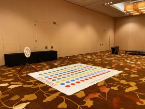 An overhead view of the Giant Twister mat featuring bright-colored circles laid out indoors, ready for rent in Singapore.