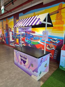 Personalized push cart rental with logo display, used at a festival for product sampling