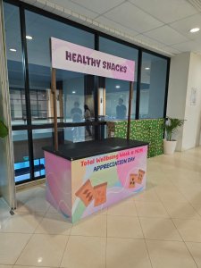 Mobile push cart with custom graphics, set up for a corporate event with colorful branding