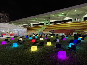 Kermit folding beach chairs and lighted led cubes event furniture set up for an outdoor movie night in Singapore