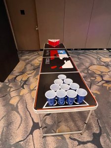 Top view of a clean beer pong table with cups lined up at both ends at Fairmont Ballroom, Singapore.