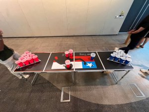 Beer pong setup with cups and ball on the table at One Marina Boulevard, Singapore.