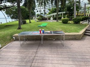 Beer pong table with red and blue plastic cups and ping pong balls ready at Shangrila Rasa Barnales, Singapore.