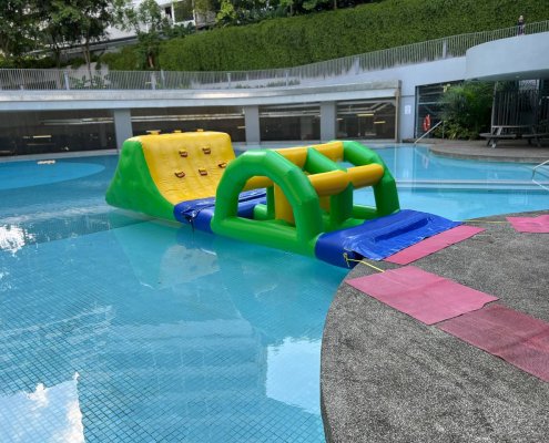 Arched inflatable obstacle named Bridge, designed with gaps under the arch.