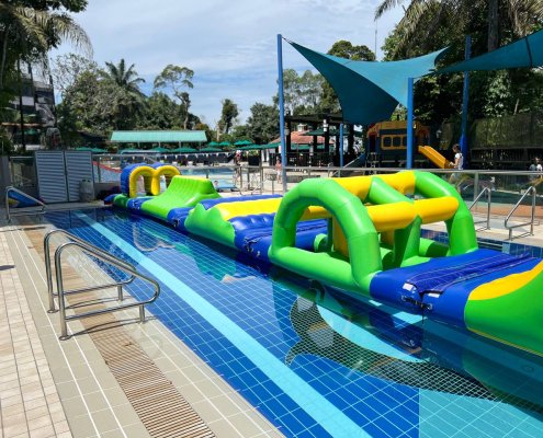 Bridge section of a water inflatable course featuring a curved structure with open spaces underneath