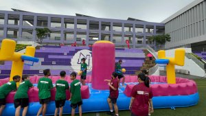 Bungee Slam Dunk - Northlight School 2 Students playing on the Bungee Slam Dunk inflatable game at Northlight School event in Singapore, enjoying an active and fun challenge.
