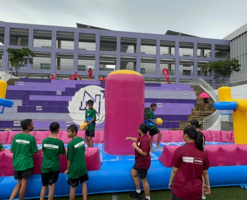 Bungee Slam Dunk - Northlight School 2 Students playing on the Bungee Slam Dunk inflatable game at Northlight School event in Singapore, enjoying an active and fun challenge.