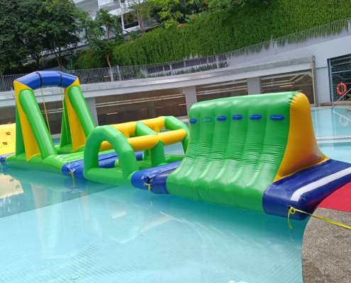 Close-up of the Cliff section from a water inflatable course, showing triangle-shaped structure with blue grips.