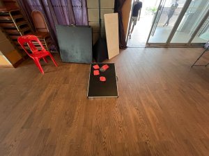 Cornhole game setup with boards and bean bags placed on the floor at Serangoon North, Singapore.