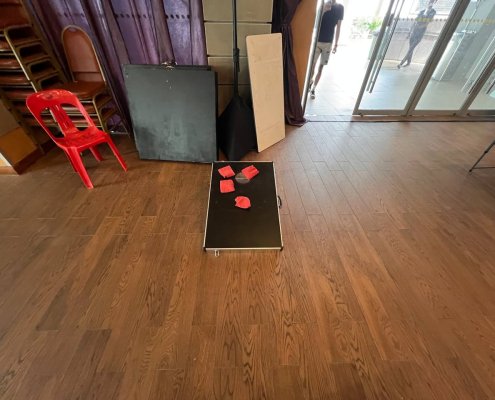 Cornhole game setup with boards and bean bags placed on the floor at Serangoon North, Singapore.