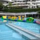 The crawl obstacle features two bright yellow arches placed on a flat inflatable platform.