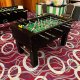 Interactive foosball game setup at Resort World Ballroom, Singapore, offering fast-paced table soccer gameplay.