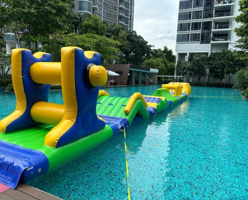 The Grind inflatable obstacle with two large yellow rollers and a wide center gap for players to pass through.