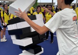 Students playing Human Jenga with a large wooden block set up at Anderson Secondary School, Singapore.