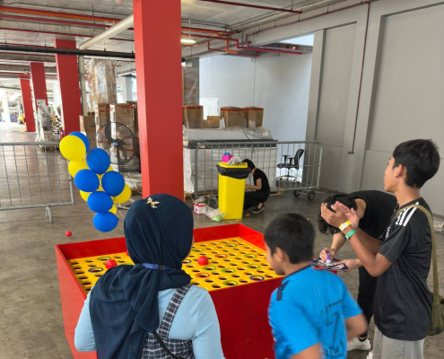 Players toss giant wiffle balls at custom targets in this exciting accuracy game, located at Green Forest Park, Singapore.