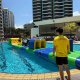 Mill - Tanamera Condo Brightly colored Mill inflatable set on water, inviting players to move around its balanced pole structure.