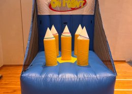 Inflatable On Point ring toss game at Northwave Condo, Singapore, featuring vibrant spikes for players to aim at.