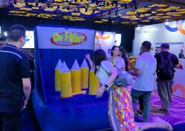 People playing the On Point inflatable game at Resort World Sentosa, Singapore, tossing rings onto bright spikes.