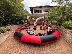 Inflatable race track setup outdoors at Queen Astrid Park, Singapore, with colorful lanes and safety barriers — ready for participants to enjoy fun, competitive racing activities.