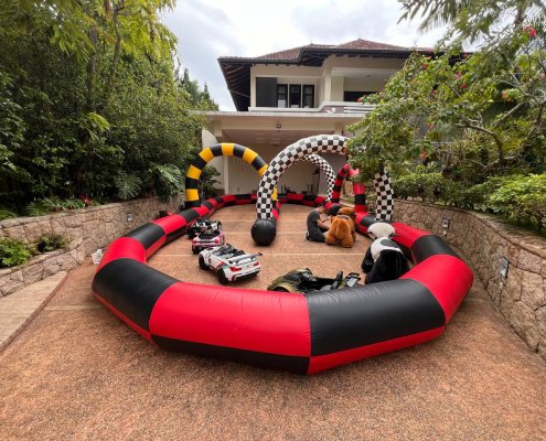 Inflatable race track setup outdoors at Queen Astrid Park, Singapore, with colorful lanes and safety barriers — ready for participants to enjoy fun, competitive racing activities.