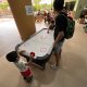 Two kids play a regular air hockey match at Eu Chin Street, Singapore.