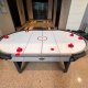 Close-up of a regular air hockey table, available to rent