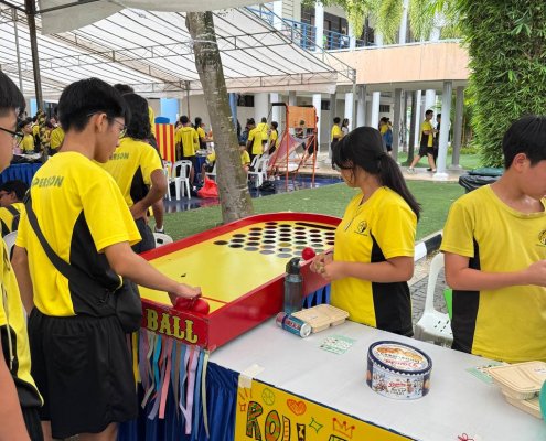 Students taking turns in a Roll a Ball game, testing their coordination at Anderson Secondary School, Singapore.