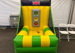 Inflatable Shuffle Balls game at Bishan Stadium, Singapore — toss colorful balls into matching holes to score points.