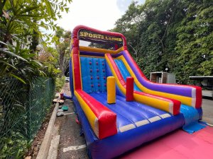 Colorful Sports Climb inflatable game at Allanbrooke Road, Singapore, featuring three inflatable pillars at the entrance and a central climbing wall