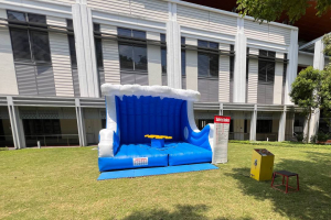 Surf board inflatable game at College Ave West, Singapore, with a moving surf board on top of a colorful inflatable base