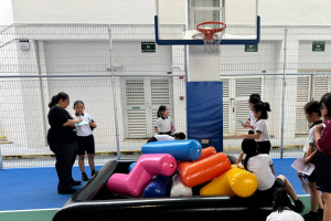 Students playing an inflatable Tetris game during a school event at Xishan Primary School, Singapore.