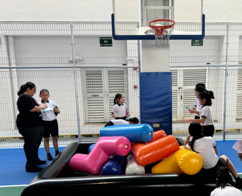 Students playing an inflatable Tetris game during a school event at Xishan Primary School, Singapore.