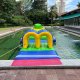 Colorful inflatable Tunnel on a water surface, forming a crawl-through path in an obstacle course.
