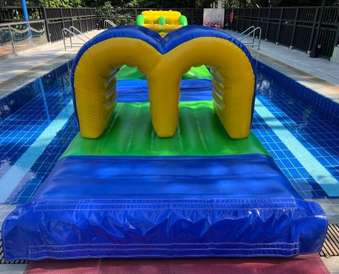 Inflatable Tunnel obstacle floating on water, designed with colorful arches for crawling through.