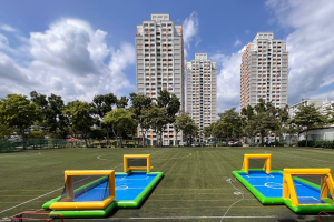 Water Soccer - Bishan Street 3 Two blue and yellow inflatable water soccer fields set up outdoors under a bright sky at Bishan Street, Singapore.