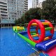 A water inflatable setup featuring twin green poles acting as a pathway or boundary in an obstacle course.