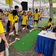 A lively putting game in action on the Big Foot Golf Putting Mats at Anderson Secondary School, Singapore, where children enjoy friendly competition and lots of laughs.
