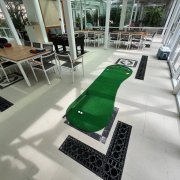 Big Foot Golf Putting Mat set up at an event at Four Seasons Condo, Singapore, featuring a green surface that mimics real grass for a realistic putting experience.
