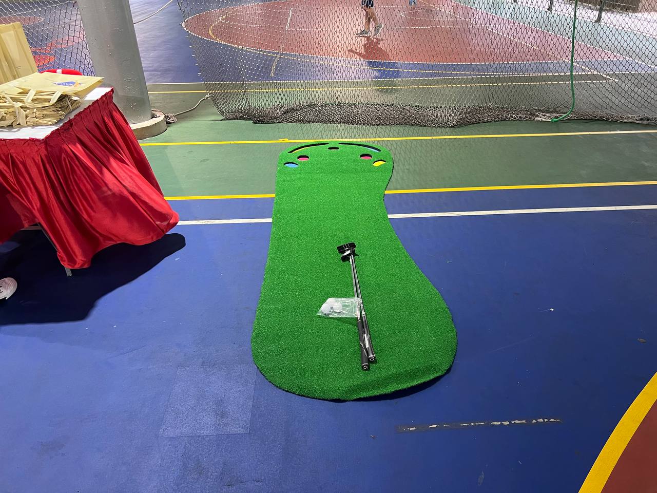 Big Foot Golf Putting Mat laid out on the ground at Woodlands Sports Pavilion, Singapore, offering a smooth, grass-like surface for putting practice.