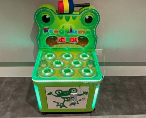 Close-up of the interactive Frog Jump game at Punggol Drive, Singapore, with bright green design and cartoon frog faces.