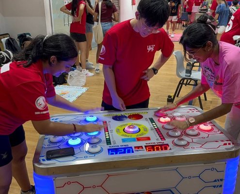 Fast-paced Naughty Beans game at National Junior College, Singapore — test your speed and reflexes in a fun head-to-head match.