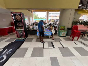 Colorful Naughty Beans arcade game at Clementi West St, Singapore — press the lights faster than your opponent to win.