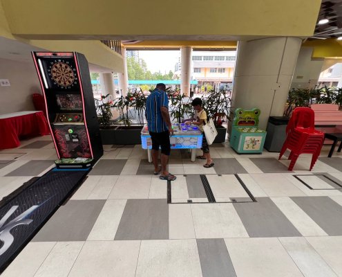 Colorful Naughty Beans arcade game at Clementi West St, Singapore — press the lights faster than your opponent to win.