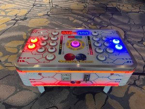 Naughty Beans arcade challenge at Fairmont Ballroom, Singapore — a fun and competitive button-tapping game for two players.