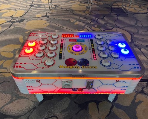 Naughty Beans arcade challenge at Fairmont Ballroom, Singapore — a fun and competitive button-tapping game for two players.