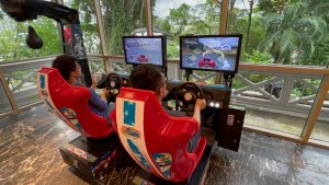 Guests playing the iconic Outrun driving arcade machine at Fort Canning Hotel, Singapore