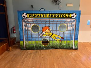 The Penalty Shootout game features a printed goalkeeper and three open holes positioned for players to aim their kicks at Tampines Fire, Singapore.