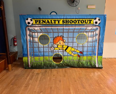 The Penalty Shootout game features a printed goalkeeper and three open holes positioned for players to aim their kicks at Tampines Fire, Singapore.